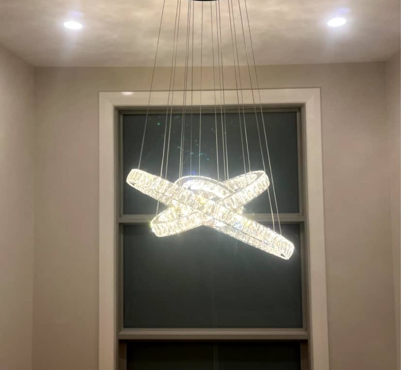 Professional electrician installing a luxury chandelier