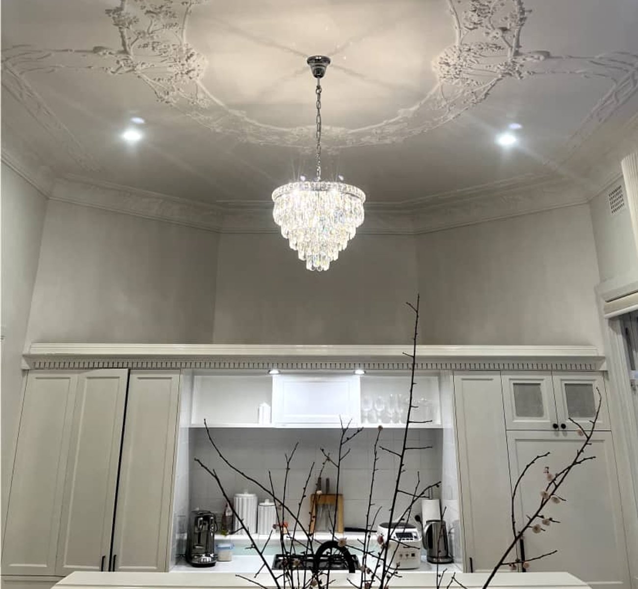 Elegant chandelier being installed by ESER Electrical expert