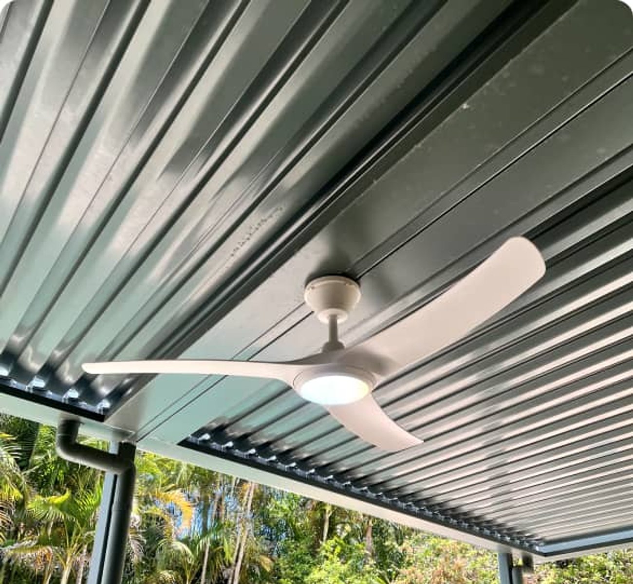 ESER Electrical team installing a ceiling fan in a spacious room