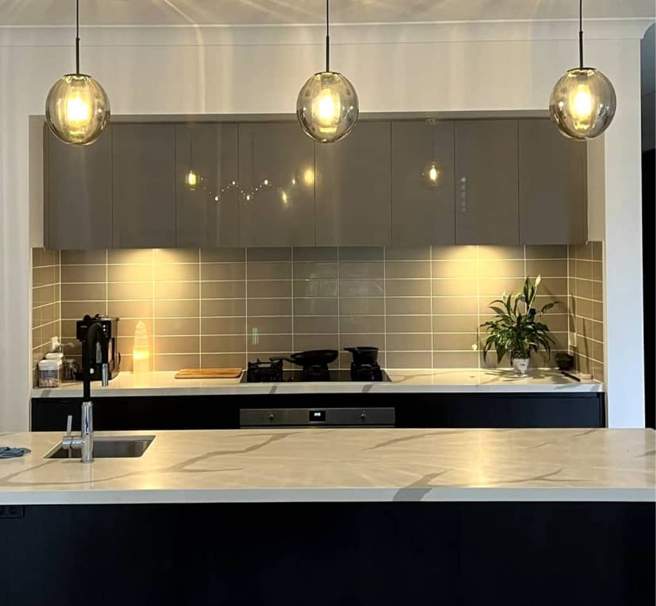 Licensed electrician installing modern lighting in a residential home