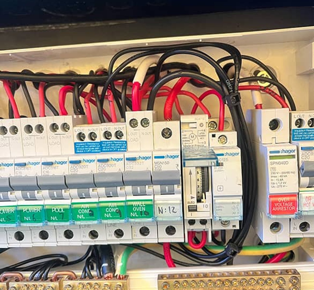 Professional electrician performing maintenance on an electrical panel