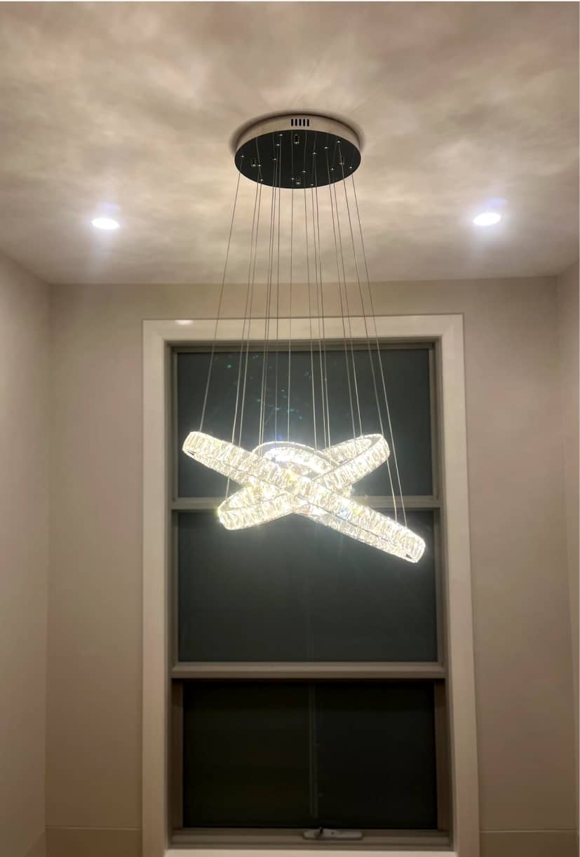 Professional electrician installing a luxury chandelier