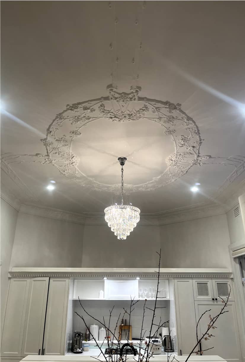 Elegant chandelier being installed by ESER Electrical expert