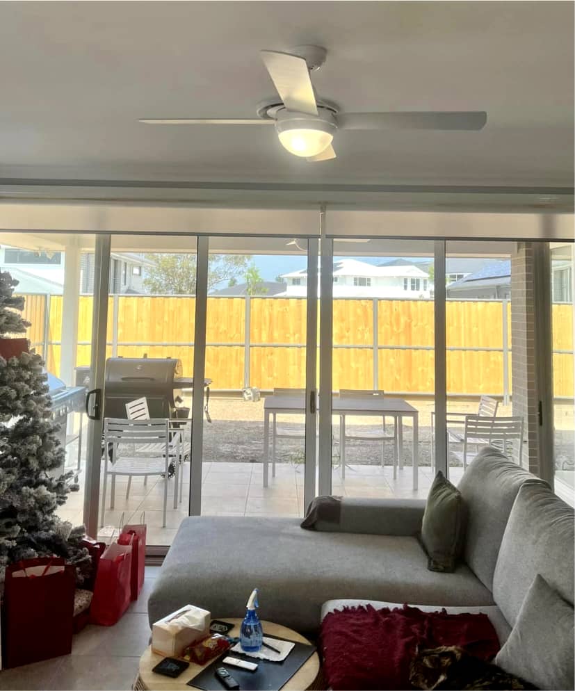 Satisfied customer enjoying a newly installed ceiling fan in their living room