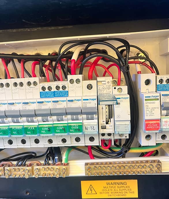 Professional electrician performing maintenance on an electrical panel